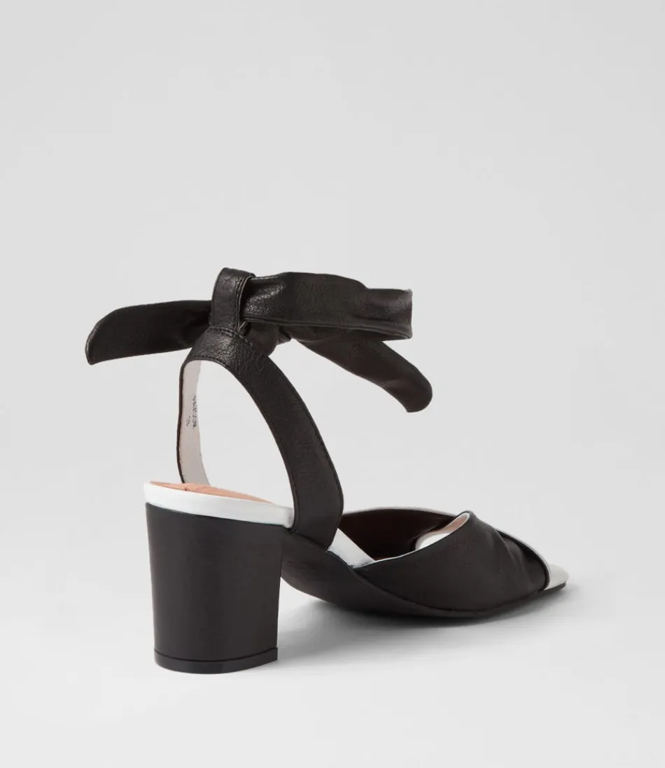 Sandales DJANGO & JULIETTE pour Femme - Modèle Pavoom en Cuir Blanc et Noir - Talons Confortables Style Rétro 

(Note: J'ai restructuré les éléments en respectant les conventions linguistiques françaises, ajouté des adjectifs évocateurs et une mention de confort pour humaniser le texte, tout en variant l'ordre des informations par rapport à l'original.)